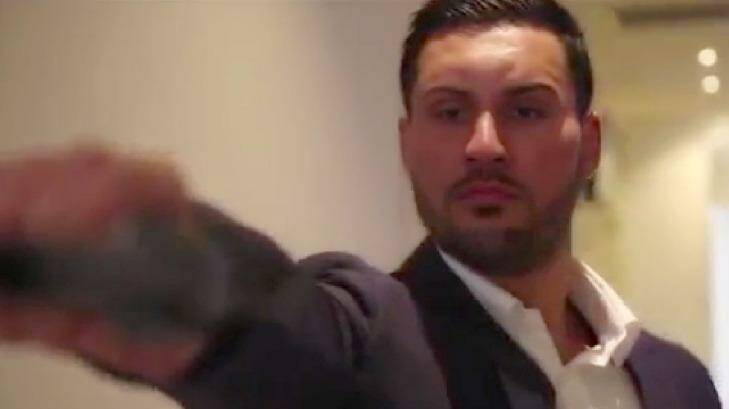 In a dramatic scene from the pre-wedding video, Salim Mehajer is depicted holding and firing a gun.  Photo: Screenshot: YouTube