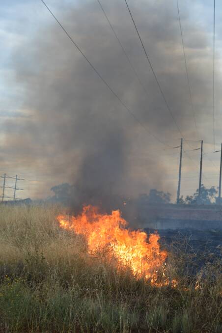 Firefighters were called to the scene of a fire on the Mudgee Road near Wellington on Tuesday that threatened the local Transgrid substation. Photo: FARREN HOTHAM.