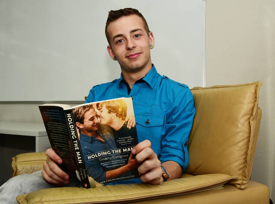 Rainbow Alliance spokesman Nicholas Steepe reads the book that inspired the film Holding the Man, scheduled for screening at Dubbo on World AIDS Day, December 1. 			   Photo: BELINDA SOOLE