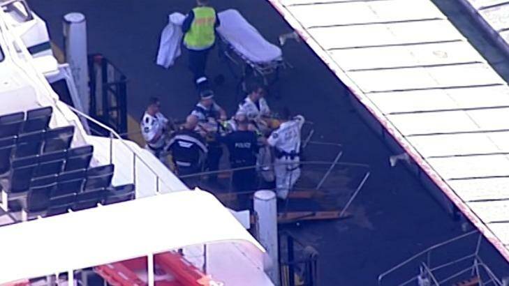 A passenger is carried from the ferry on a spinal board. Photo: Nine News