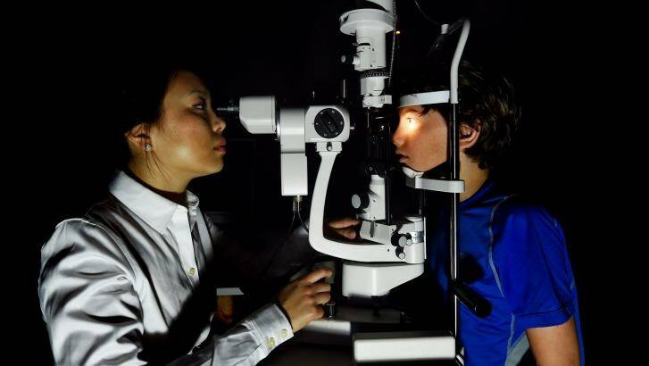 Maxime Jalbert-Locke, right, has an eye examination conducted by Dr Pauline Kang. Photo: Kate Geraghty