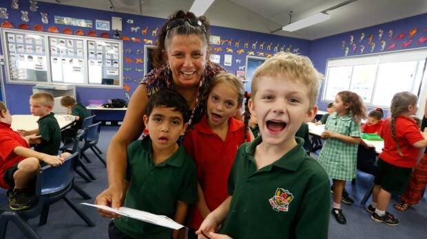 Indigenous language classes at Dubbo West Public School: Diane McNaboe, teacher of Aboriginal language and culture, with Bryson (left), Lily and Thomas singing a song. Photo: Peter Rae