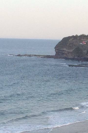 Cliff fall: a rescue helicopter arrives at Warriewood beach. 