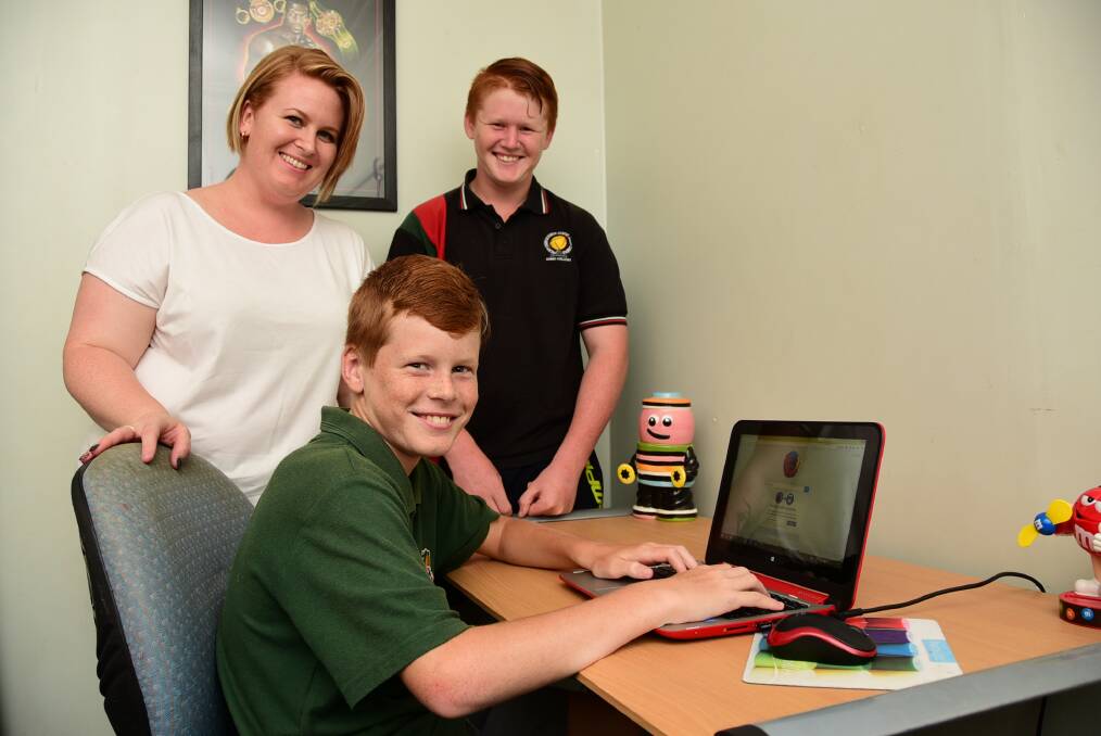 Malinda Bateup, with her two sons Billy, who is in Year 8 and Thomas who is in Year 6, joined the Smith Family's Saver Plus program which helped them purchase items such as a new laptop.PHOTO: BELINDA SOOLE