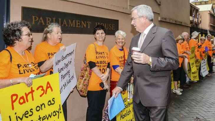 Planning Minister Brad Hazzard listens to Warriewood and Bronte protesters outside Parliament House. Photo: Michael Mannington