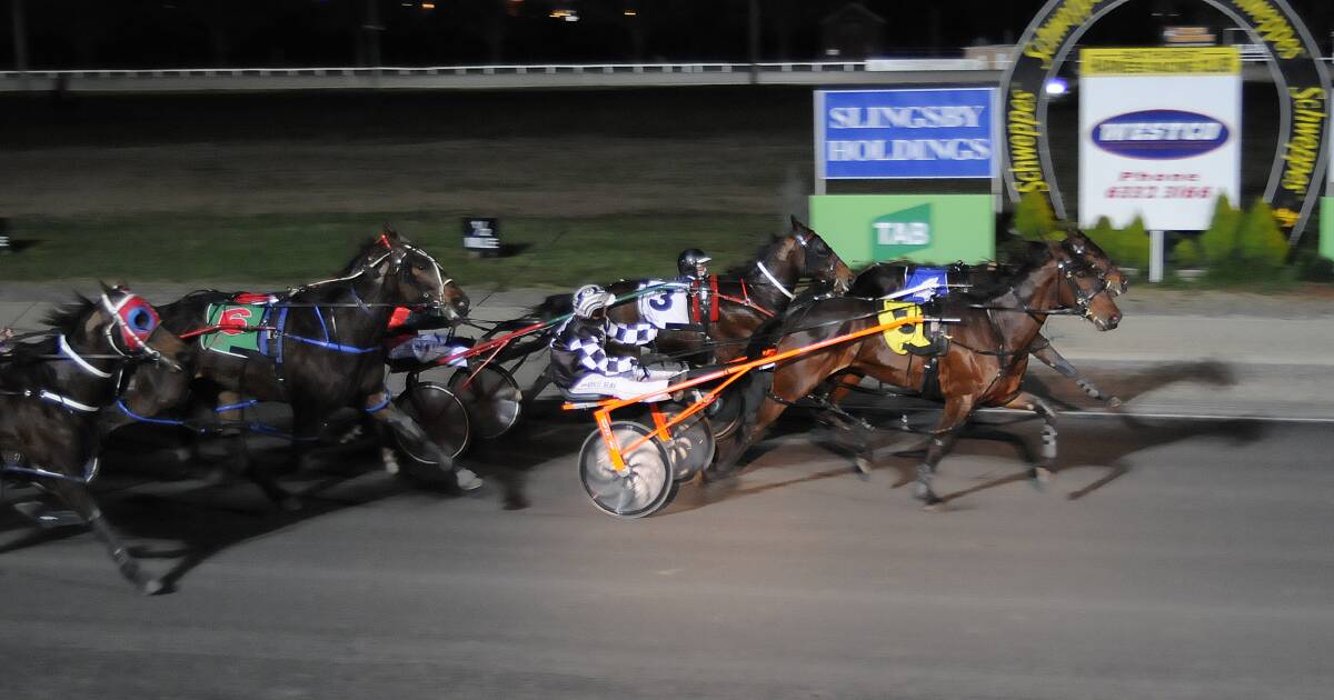 Red Vee Hanover (outside) hangs on to win at Bathurst Paceway on Wednesday night. 	Photo: CHRIS SEABROOK