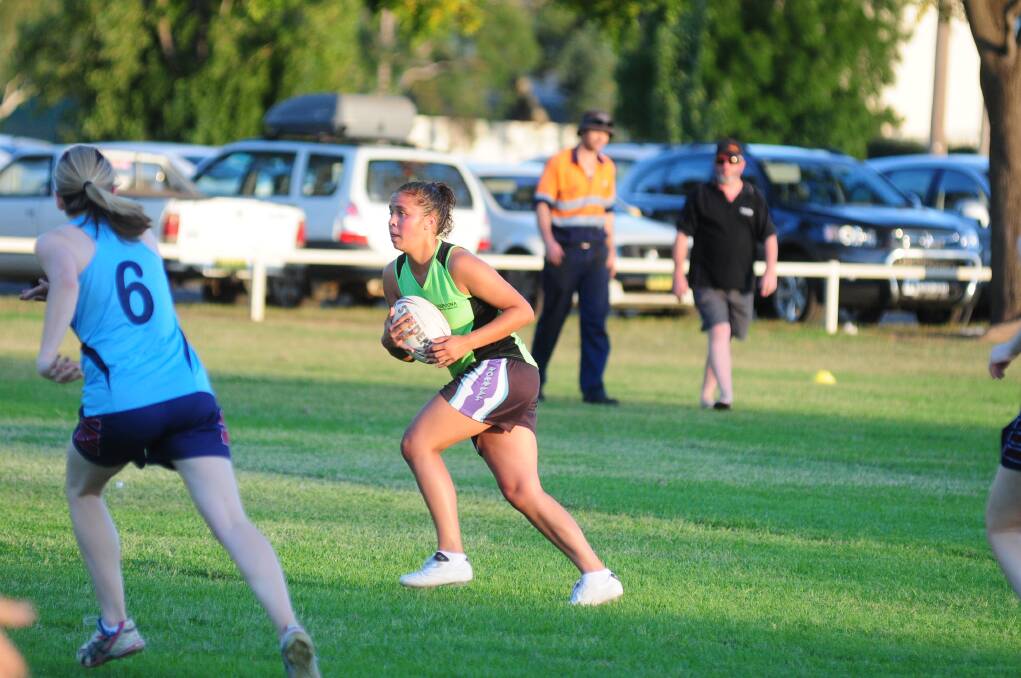 Kimberlee Gordon takes the ball up for the Thuroona Asbestos Removal team.
