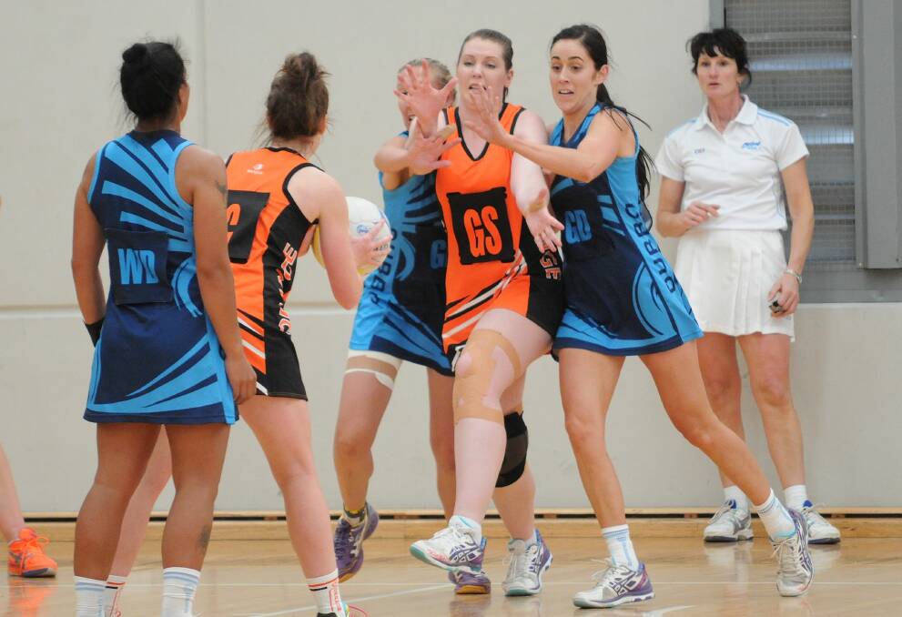 Emily Willmot leads the Dubbo defence as they look to block access to Orange shooter Sinead Davis.  
Photo: Steve Gosch
