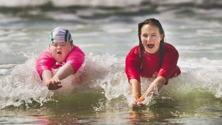 Georgia Brown, 12, is part of the Starfish Nippers program at the Anglesea Surf Club. She is photographed with her trainer Greta Dickson learning how to swim in the surf. Photo: Simon_O'Dwyer