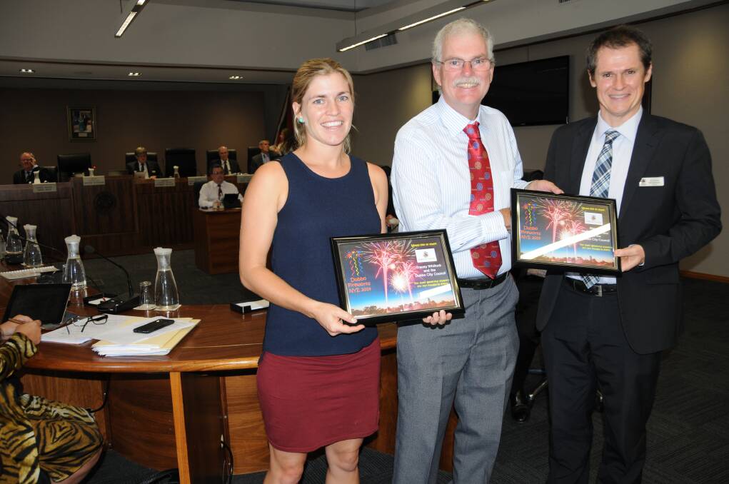 Dubbo Fireworks Inc chairman Peter Judd presents Dubbo City Council recreational planning and programs manager Tracey Whillock and Dubbo Mayor Mathew Dickerson with certificates of appreciation after the success of New Year s Eve 2014. 		   Photo: HANNAH SOOLE