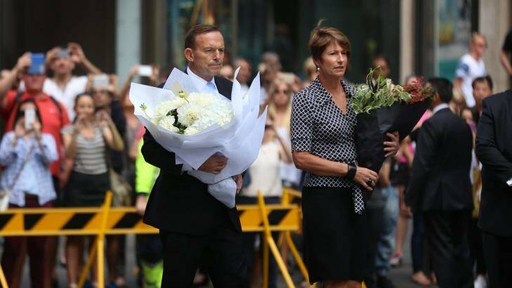 "I'll be doing more": Prime Minister Tony Abbott and his wife Margaret arrive at Martin Place on Tuesday to pay their respects. Photo: James Alcock