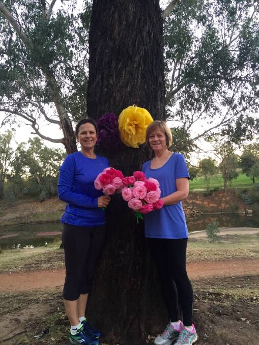 Dubbo parkrun run director Karen Pellow and volunteer Deb Aldis with some of the flowers ready for Mother s Day at parkrun.                             Photo: CONTRIBUTED