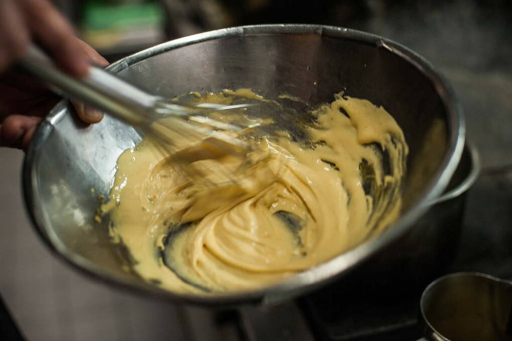 Step 3: Add butter to strained mixture, whisking continuously until a thick consistency. Photo: Josh Robenstone/Getty Images