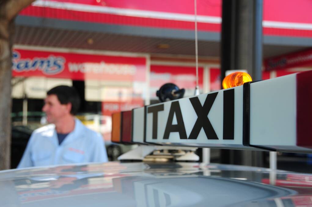 A Dubbo taxi driver on the Dubbo Shopping Square taxi rank in Macquarie Street.	      Photo: GREG KEEN