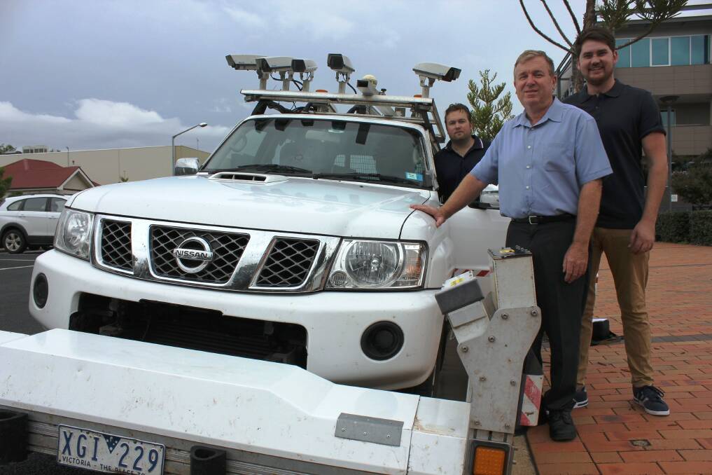 Dubbo City Council asset systems engineer Michael McCulloch (centre) and Joel Bradley and Ryan Warren from Australian Road Research Board with the road condition survey vehicle. 	Photo: contributed