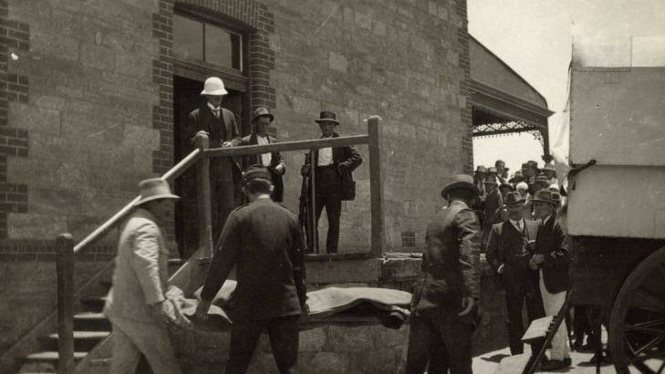 After two men attacked a picnic train in Broken Hill on New Year's Day 1915 one of their bodies is moved to the morgue. Photo: Broken Hill City Library