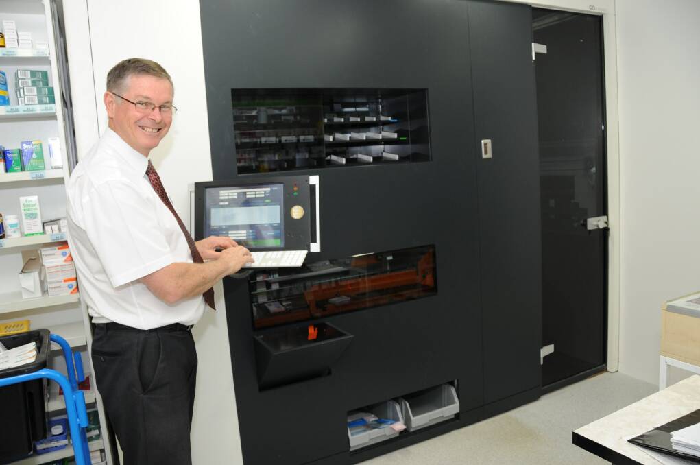 Priceline Pharmacy partner Mark Rugendyke with his new machine that sorts, stores and dispenses presriptio medicine with 100 per cent accuracy. Photo: BELINDA SOOLE