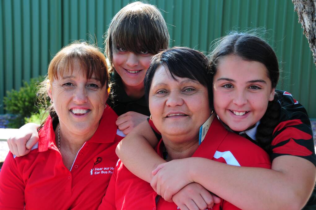 Dubbo West Public School captains Simon Ramirez and Brooke Pilcher thank Heart Our Heart Ear Bus representatives Rachel Mills and Tracey Walford for their help in diagnosing hearing problems at the school. Photo: GREG KEEN