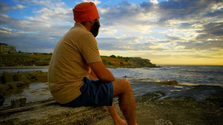 Tourist Parminder Singh from India watches the sun rise at Clovelly Beach on Tuesday morning. Photo: Kate Geraghty