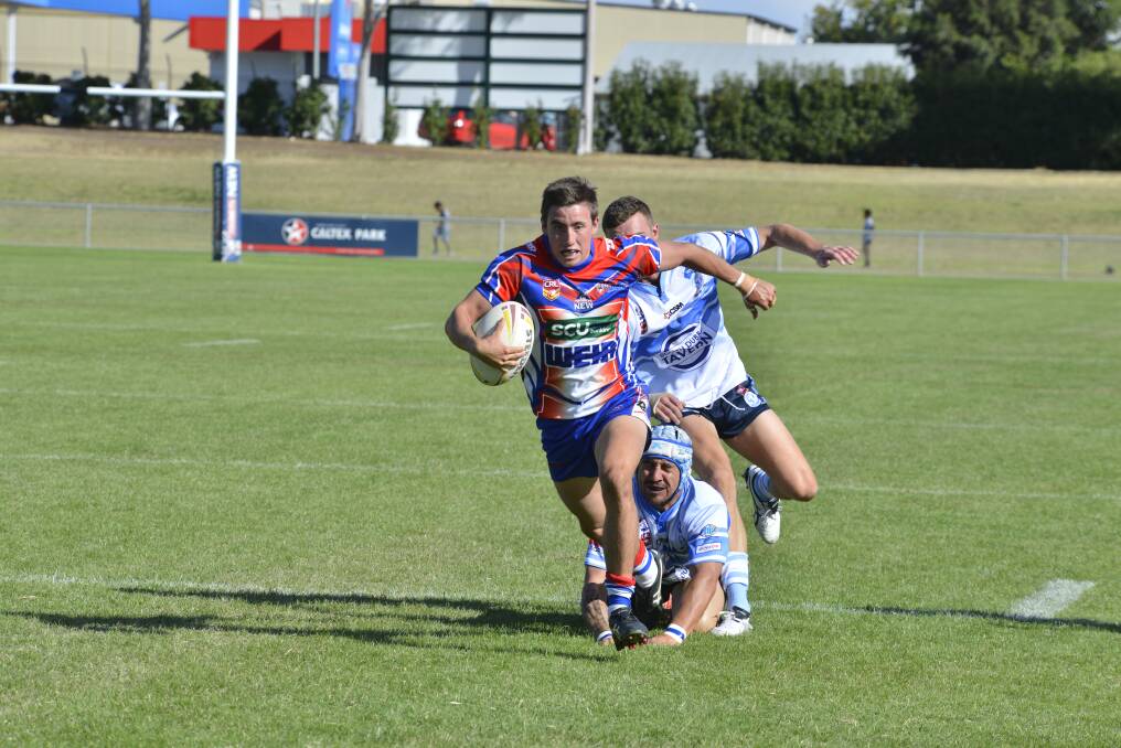 Sam Dwyer, pictured on his way to scoring a try in Parkes recent trial win over Macquarie, has again been named at fullback for Group 11.		  Photo: BELINDA SOOLE