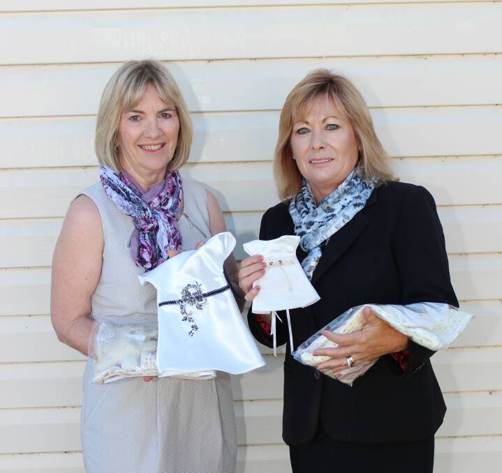 Angel Gowns for Australian Angel Babies volunteer Julie Prout of Gilgandra presents angel gown packages to Barbara Carter of W Larcombe and Sons. 													 Photo: GILGANDRA WEEKLY