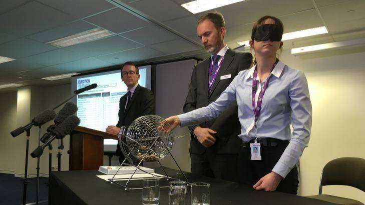 Australian Electoral Commission officials conduct the draw for the Queensland Senate ballot paper. Photo: Cameron Atfield