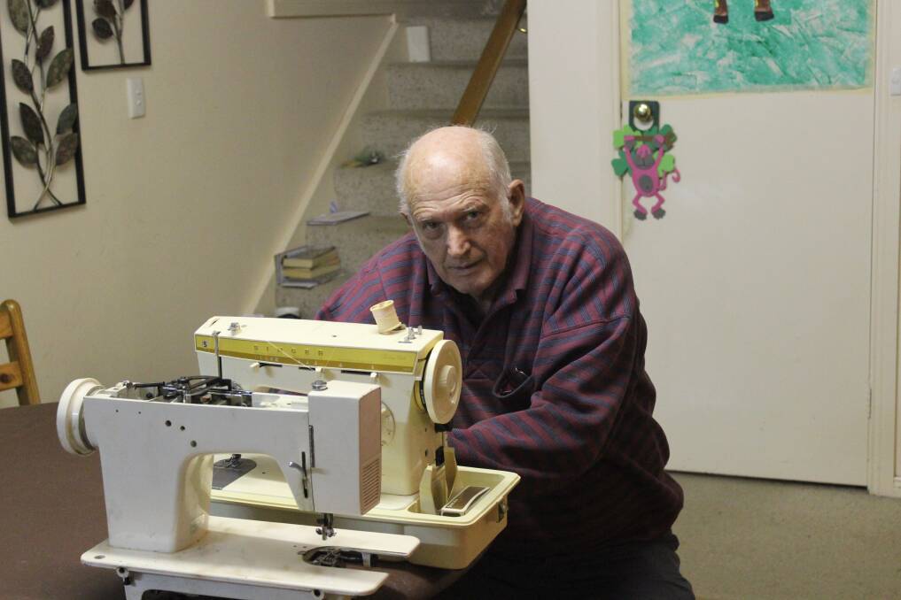 Geoff Higgins with a couple of the sewing machine s to be sent to the Philippines.