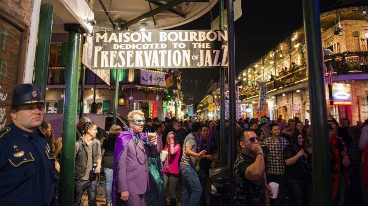 Revelers crowd Bourbon Street New Orleans, Louisiana.