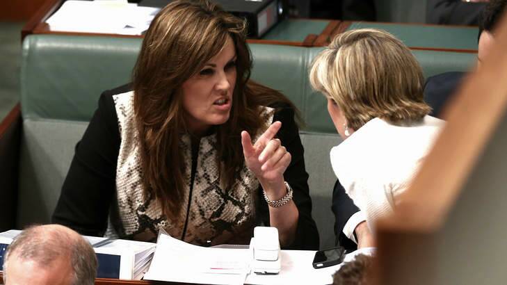 Tony Abbott's chief of staff Peta Credlin talks to Foreign Minister Julie Bishop during question time in Parliament on Monday. Photo: Alex Ellinghausen