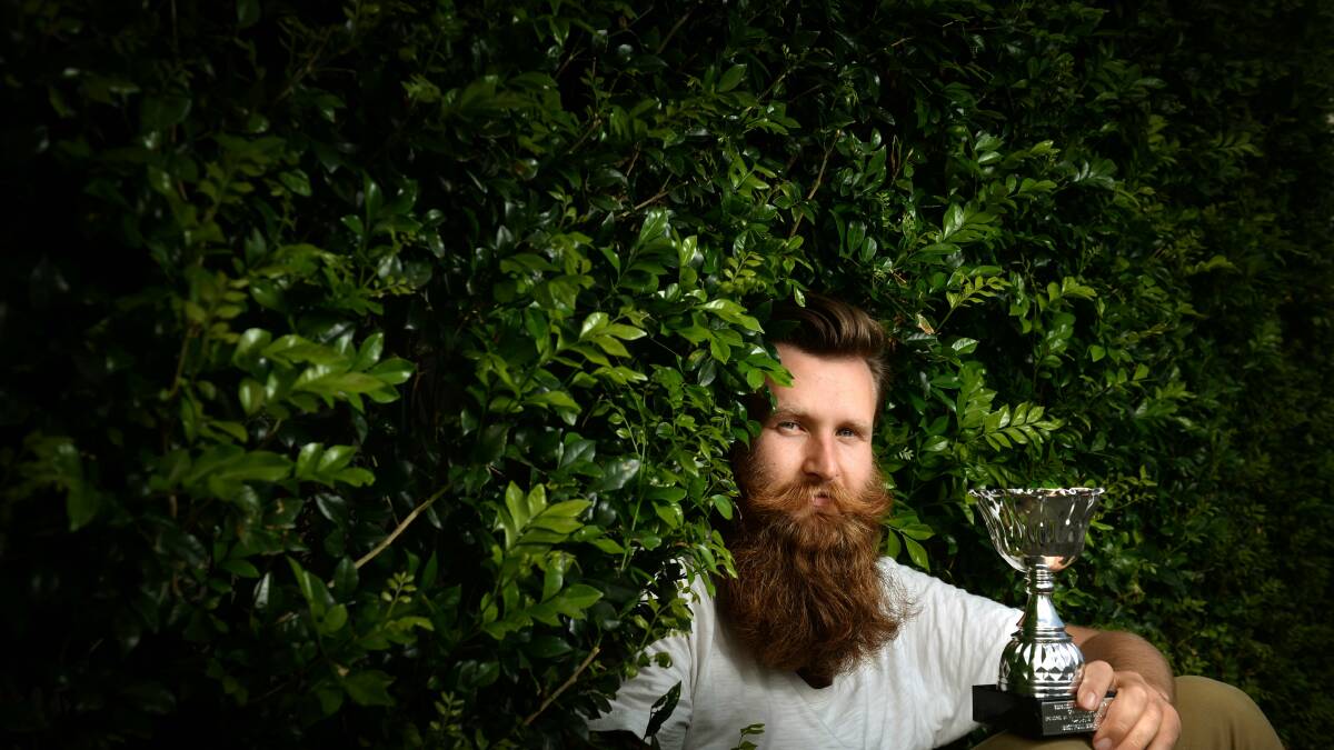 HAIR YOU GO: Max Mason-Hubers and his Best Full Beard trophy. Picture: Marina Neil