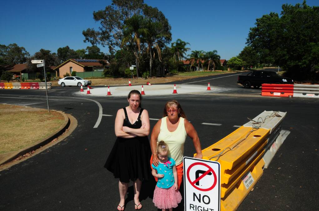 Rebecca Boehme, Annette Webber and (front) Mathilda Boehme at the roundabout that they say is poorly-designed. 
 Photo: GREG KEEN