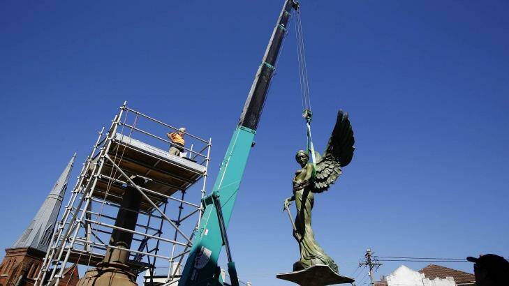 The Winged Victory statue is hoisted by a crane on to her final resting place in front of the Marrickville Town Hall.  Photo: Jessica Hromas