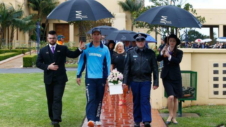 Lifeguard Brad Rope and police officer Andrew Carter carry Lily Grace's coffin during the baby's funeral. Photo: Daniel Munoz
