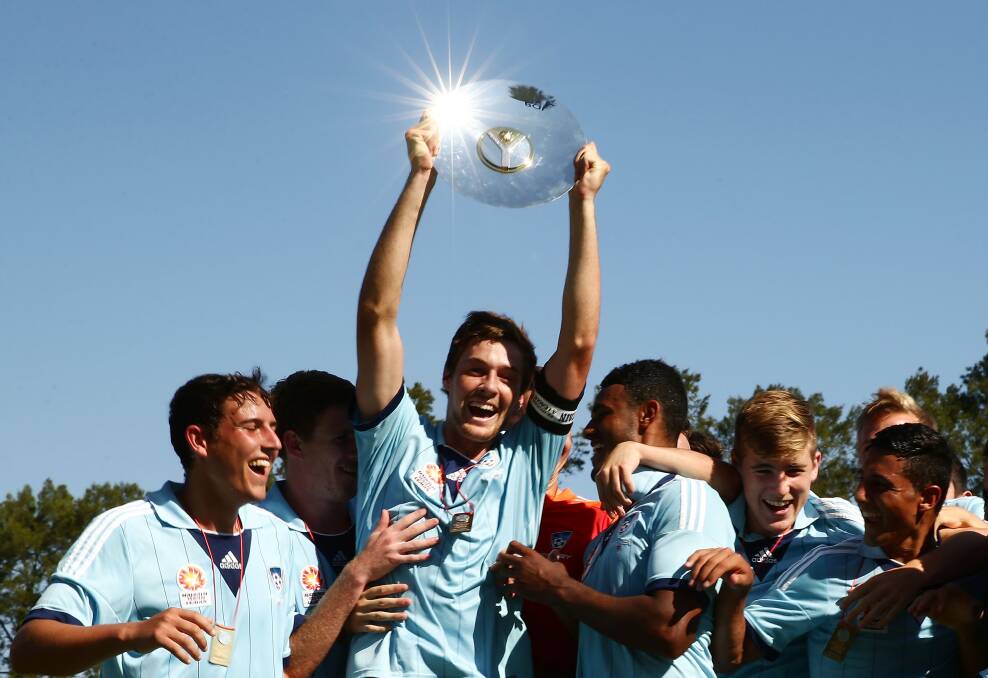 Dubbo's Jacob Tratt, pictured celebrating with the National Youth League trophy in 2014, signed a professional contract with Sydney FC on Tuesday. 	Photo: GETTY IMAGES