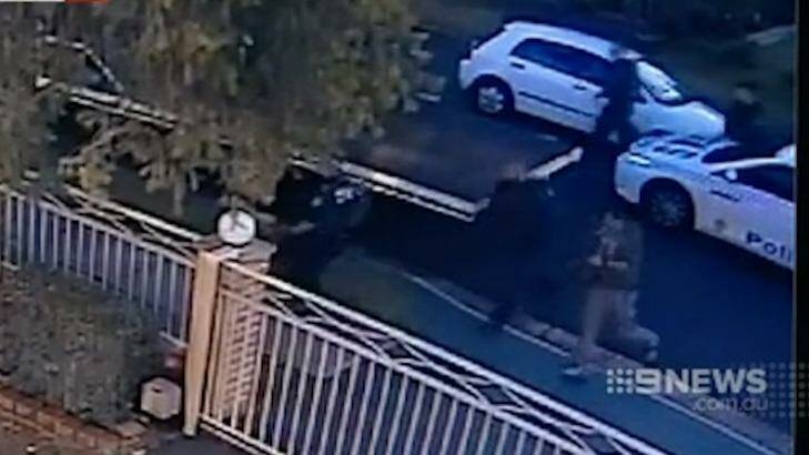 Officers run to surround the truck after it runs out of petrol, in CCTV from a Colechin Street house. Photo: Nine News