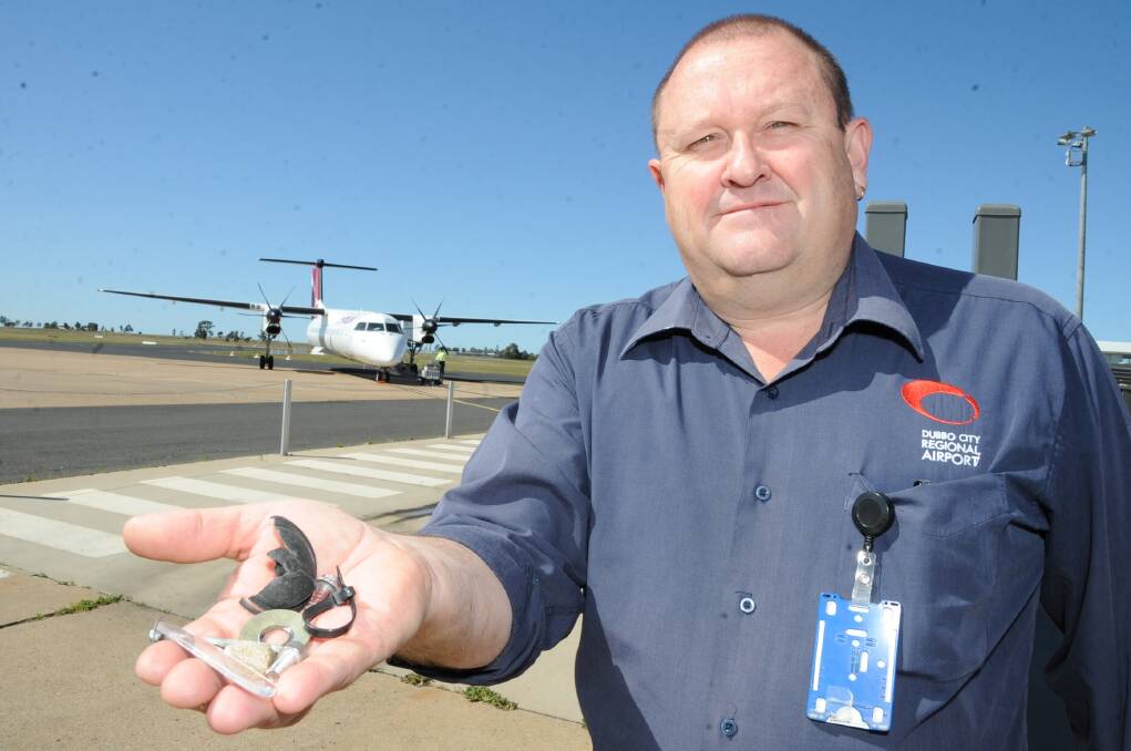ABOVE: Dubbo City Council's airport operations manager Lindsay Mason with objects collected from on and around the runways. 
 Photo: BELINDA SOOLE.