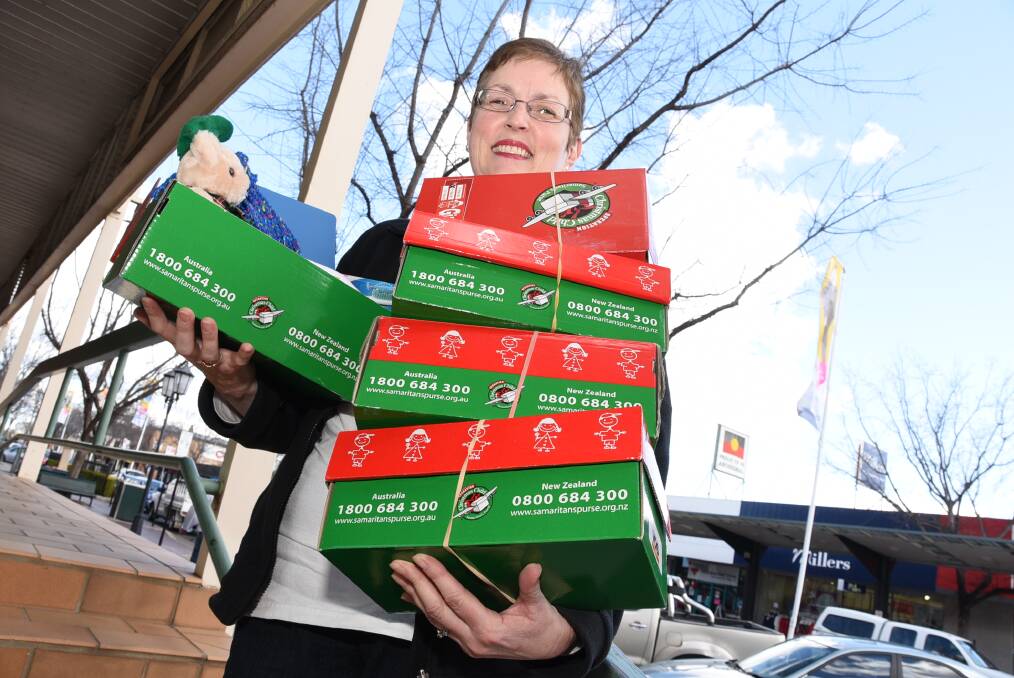 Operation Christmas Child area co-ordinator Sylvia Paice with some of the shoeboxes that will be sent overseas to children in need. 							  Photo: BELINDA SOOLE