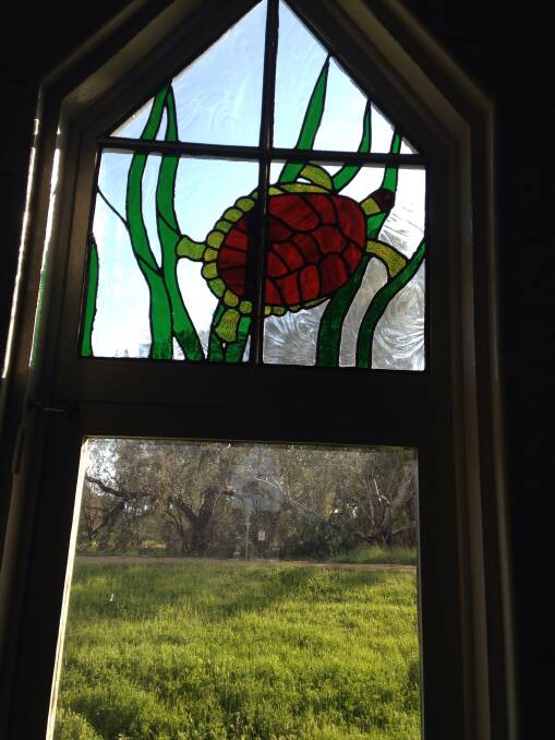 This leadlight window in Warren's Window on the Wetlands Centre features a turtle.	Photo: Contributed