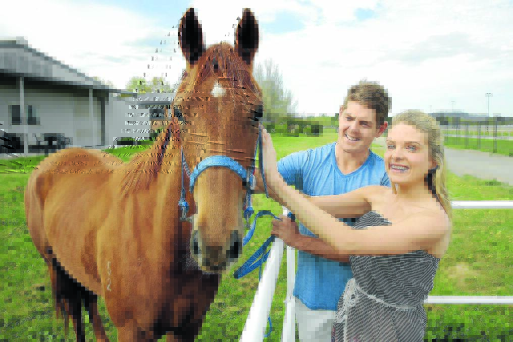 Erin Molan and Daniel Hughes inspect their two-year-old filly at Canberra earlier this year. 				       Photo: JEFFREY CHAN