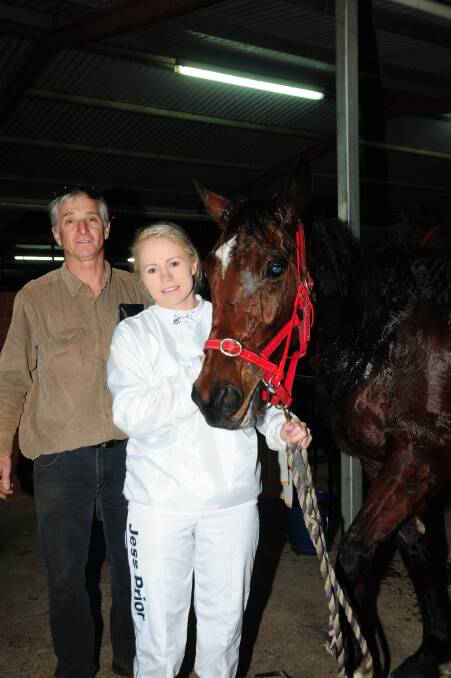 Trainer Peter Bullock and stablehand Jess Prior with The Wife's Calling, which won the race named in honour of Jess Sutton on Friday night.  
Photo: JACKIE PRATTEN