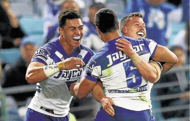 SYDNEY, AUSTRALIA - AUGUST 21:  The Bulldogs celebrate a try by Sam Perrett during the round 24 NRL match between the South Sydney Rabbitohs and the Canterbury Bulldogs at ANZ Stadium on August 21, 2015 in Sydney, Australia.  (Photo by Mark Nolan/Getty Images)