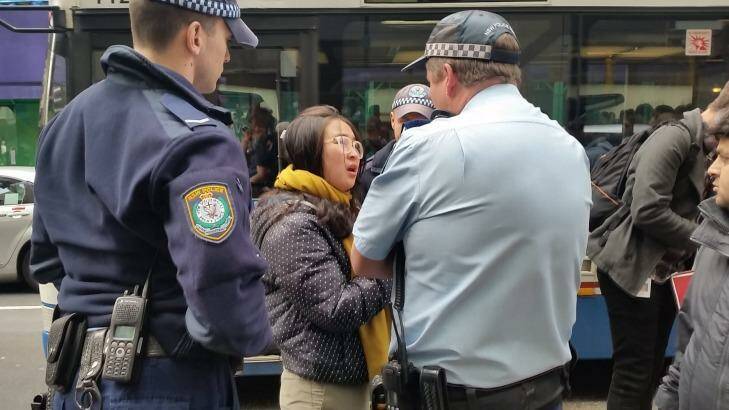 Police order a young woman outside the Sydney Apple store to move on. Photo: Hannah Francis
