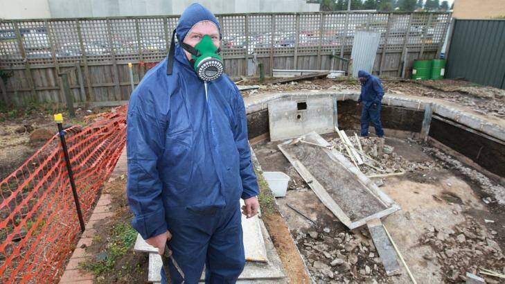 Andrew Morrison, and a colleague removing asbestos linings from an old in-ground pool. Photo: Glen Watson