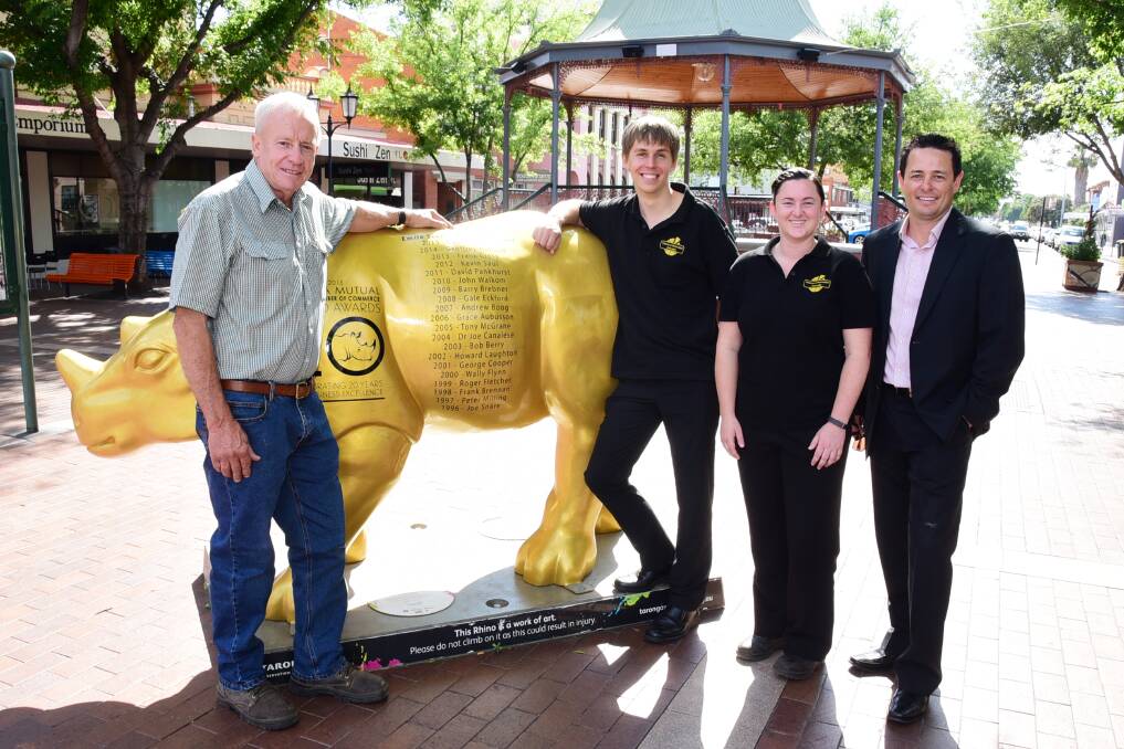 Colin Honeysett, Abraham Damen, Lee Bayliss and Dubbo Chamber of Commerce president Matt Wright look over the engravings on the Gold Rhino on Wednesday. 												    Photo: BELINDA SOOLE