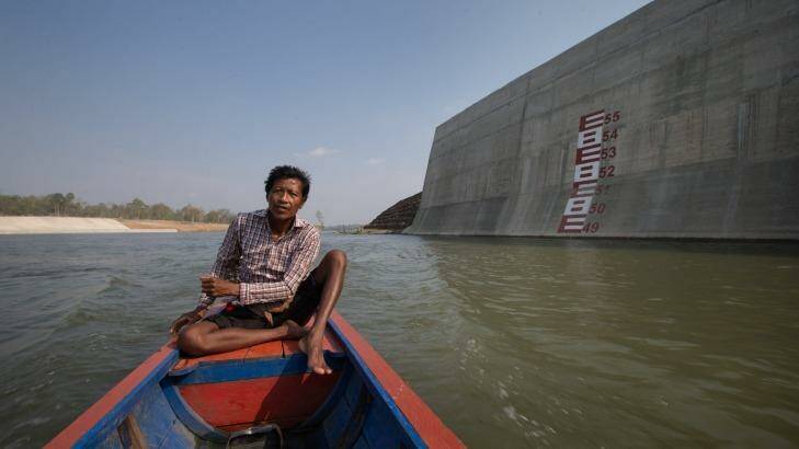 Ota Khami drives his boat where his home used to be. Photo: Jason South