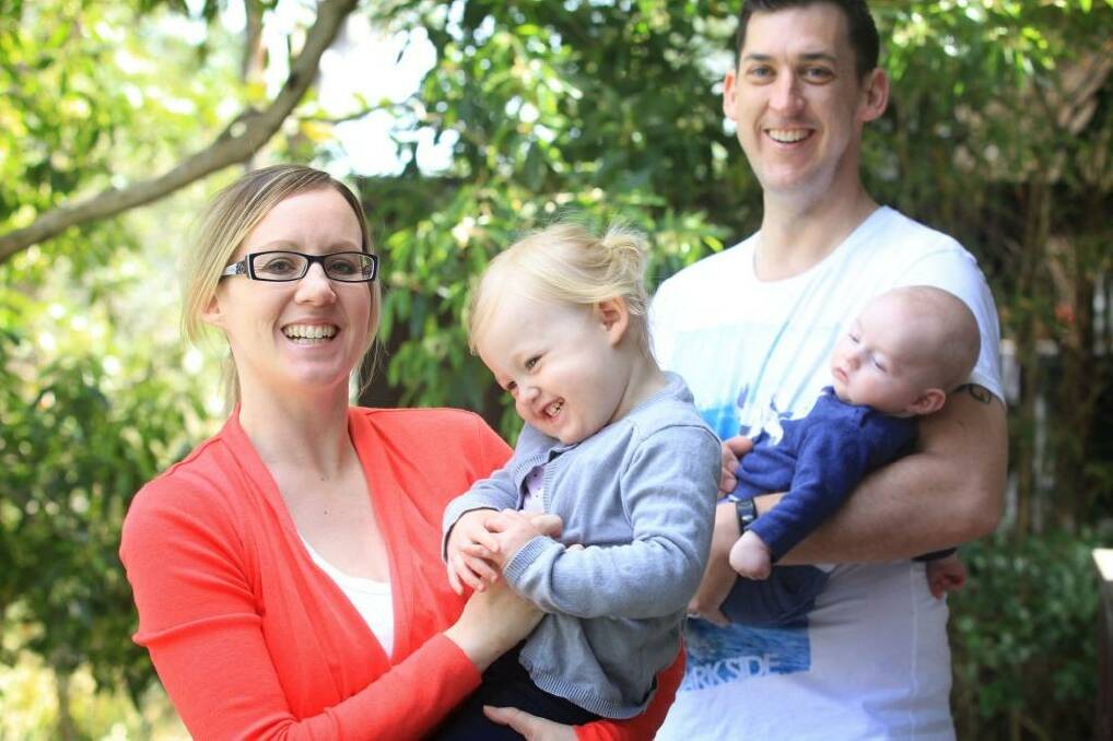 Kate Wild with her children Poppy (aged 2) and William (aged 3 months) and her husband Brendon at their Westleigh home. Photo: James Alcock