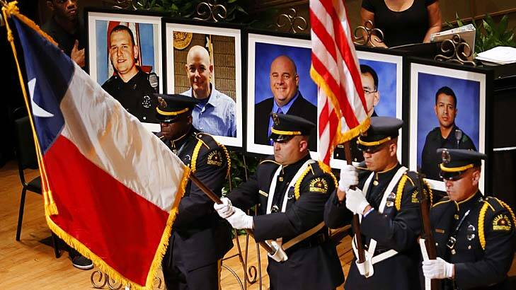 The Dallas Police colour guard presents the colours before the photos of five fallen officers at an interfaith memorial service. Photo: Tom Fox