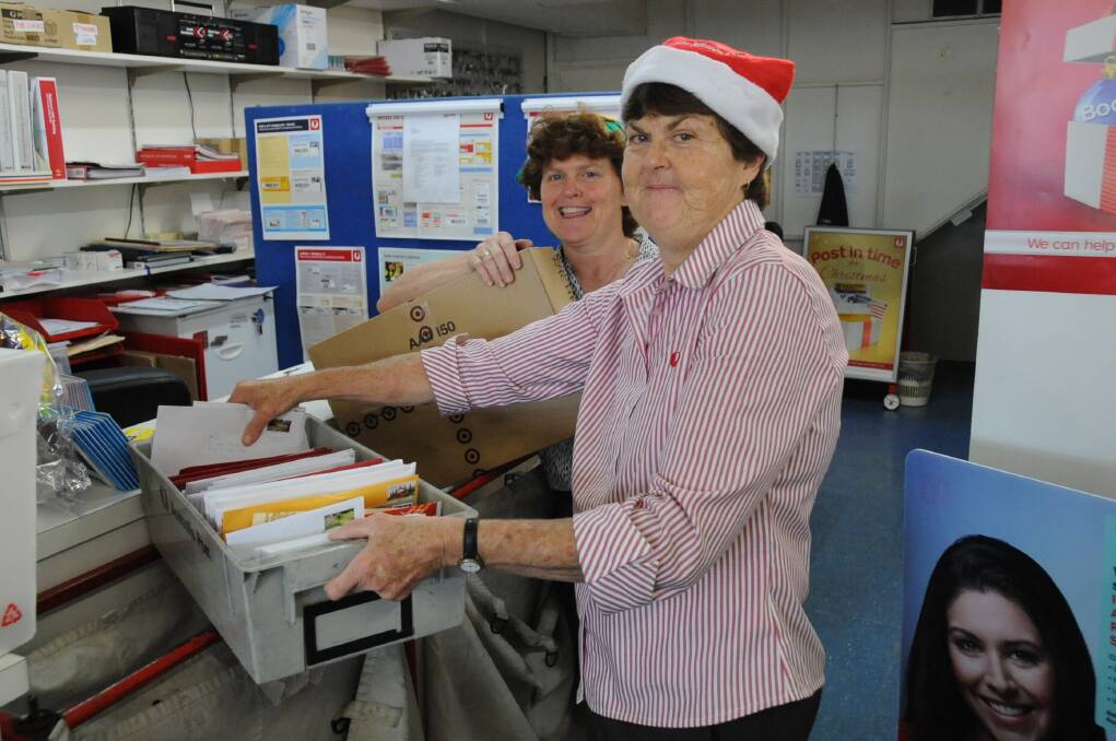 Owners of the Dubbo Grove Post Office Leanne and Janelle Fulwood preparing for the last of the Christmas post. Photo: HANNAH SOOLE.