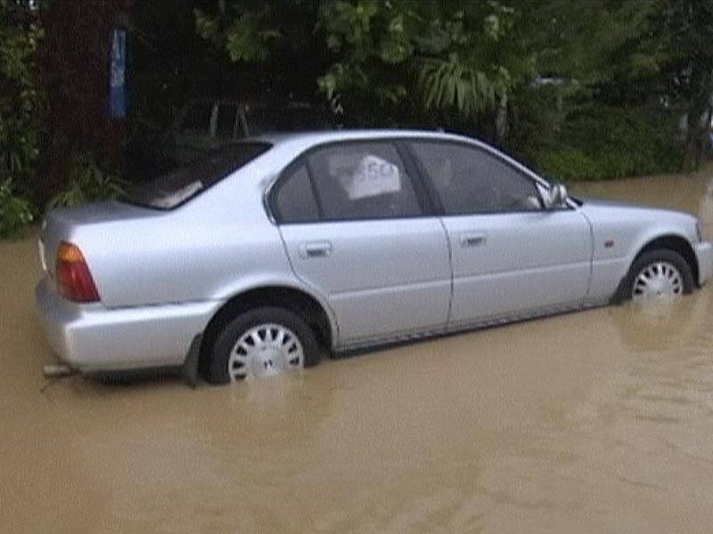 Flood waters from ex-cyclone Gita surround a vehicle in Nelson, New Zealand.