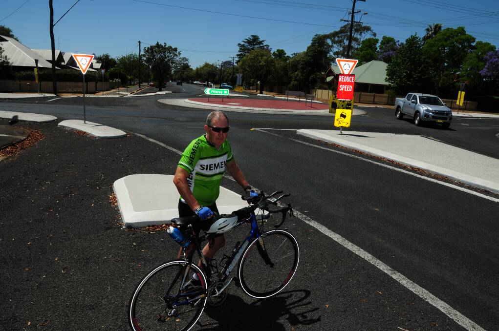 Trevor Youngman and his bike were left worse for wear after he crossed a large collection of stones banked up outside a roundabout in Fitzroy Street.					        Photo: GREG KEEN